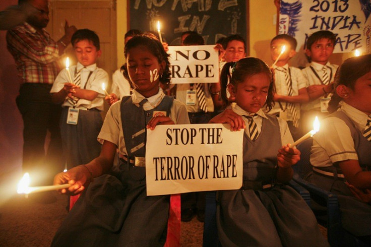Students hold candles during prayer for Delhi gang rape victim