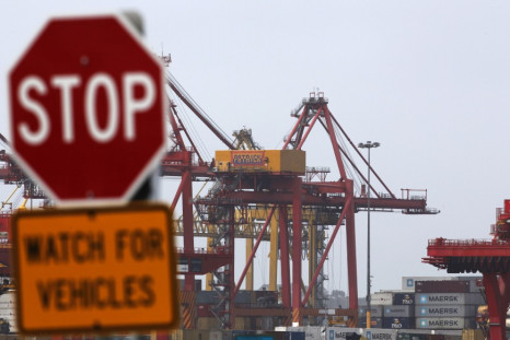 A traffic sign stands in front of cranes at the Port of Botany, near Sydney