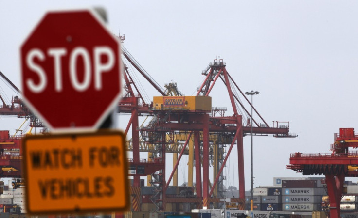 A traffic sign stands in front of cranes at the Port of Botany, near Sydney