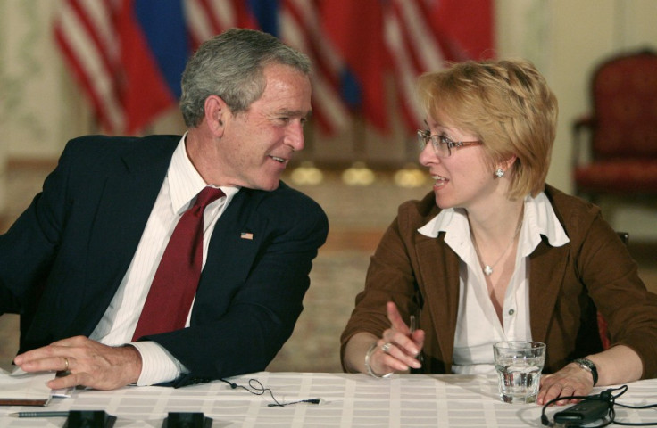 U.S. President George W. Bush speaks with Irina Yasina, representing Open Russia, as they participate in a roundtable discussion with Civil Society in St Petersburg, Russia, July 14, 2006
