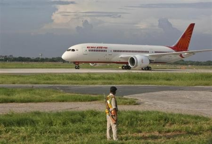 A security personnel stands guard as Air India's Dreamliner Boeing 787 taxies upon its arrival at the airport in New Delhi September 8, 2012.