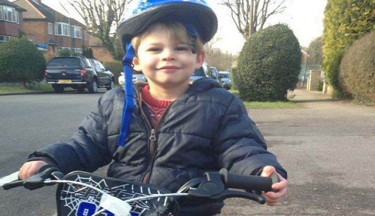 Zachary plays happily on bike near home