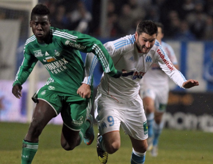 Kurt Zouma (L) battles for the ball with Marseille's Andre-Pierre Gignac