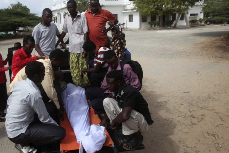 Somali residents arrive with the body of Mohamed Nuxurkey, a local journalist who died in Monday's blast