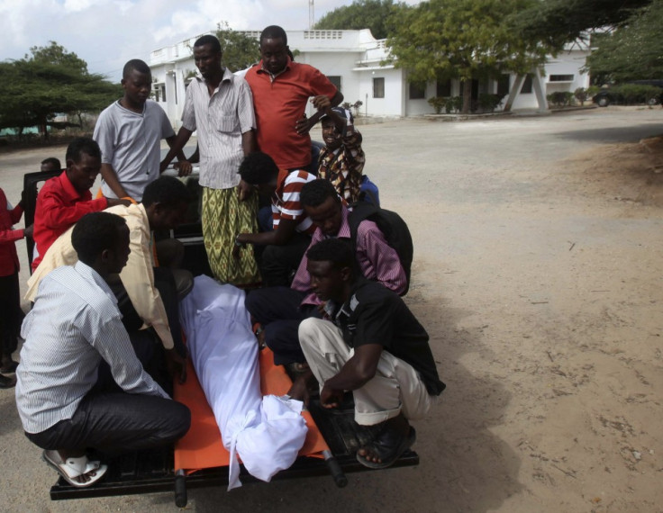 Somali residents arrive with the body of Mohamed Nuxurkey, a local journalist who died in Monday's blast