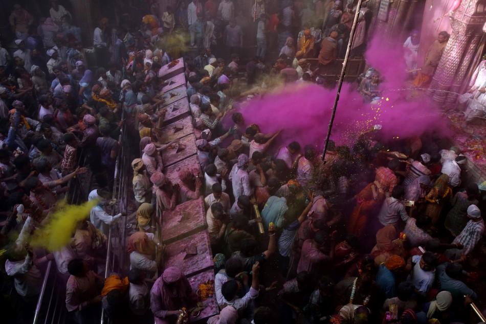Hindu devotees throw coloured powder during Holi celebrations at the Bankey Bihari temple in Vrindavan in the northern Indian state of Uttar Pradesh March 26, 2013. Holi, also known as the Festival of Colours, heralds the beginning of spring and is celebr