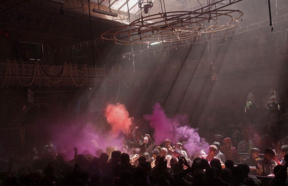 Hindu devotees throw coloured powder into the air during holi celebrations at the Bankey Bihari temple in Vrindavan in the northern Indian state of Uttar Pradesh March 25, 2013. Holi, also known as the Festival of Colours, heralds the beginning of spring