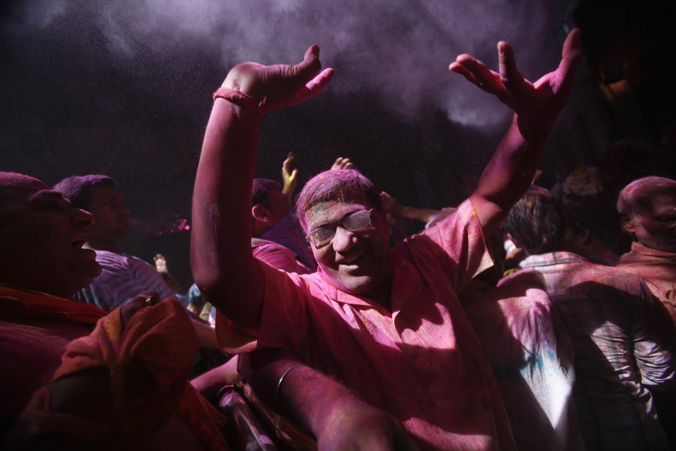 A man dances during holi celebrations at the Bankey Bihari temple in Vrindavan in the northern Indian state of Uttar Pradesh March 25, 2013. Holi, also known as the Festival of Colours, heralds the beginning of spring and is celebrated all over India.