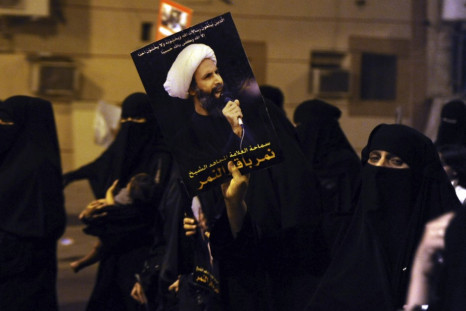 A protester holds up a picture of Sheikh Nemer al-Nemer during a rally at the coastal town of Qatif (Reuters)