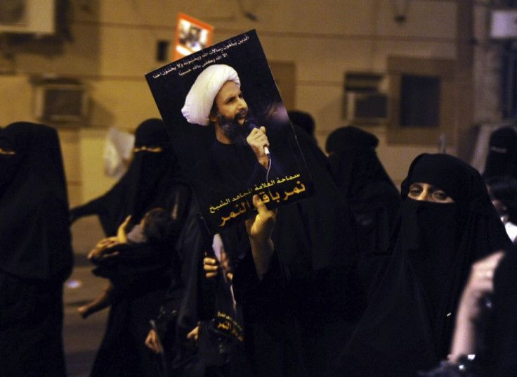 A protester holds up a picture of Sheikh Nemer al-Nemer during a rally at the coastal town of Qatif (Reuters)