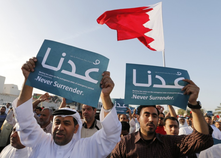 Anti-government protesters holding banners reading "Never Surrender" march during a demonstration