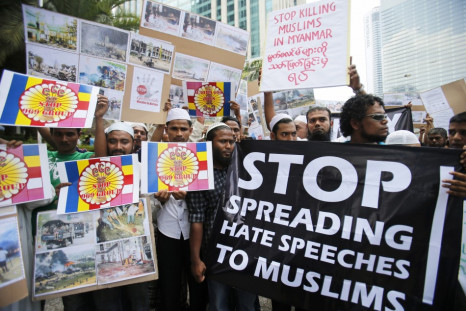 Myanmar Muslims living in Malaysia show banners and placards during a demonstration against the killings of Muslims