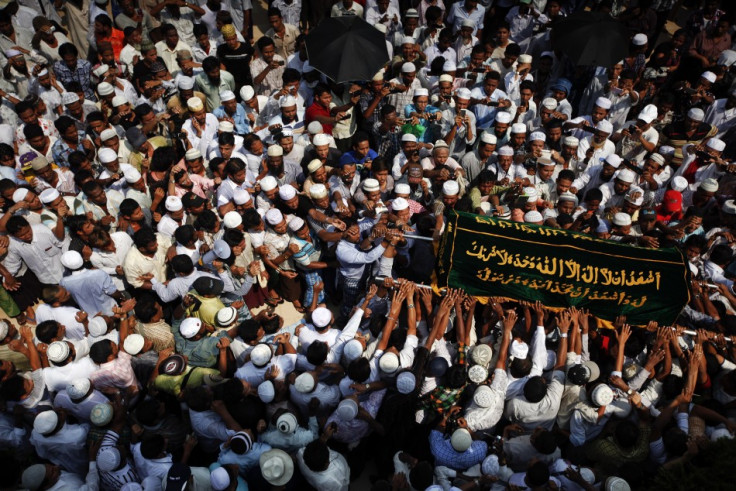 People carry a coffin during the funeral for victims of a fire at Yaeway cemetery