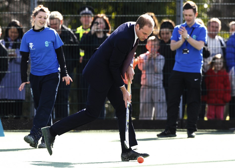 Britains Prince William plays hockey during a visit with his wife Catherine, Duchess of Cambridge to the Donald Dewar centre in Glasgow, Scotland April 4, 2013
