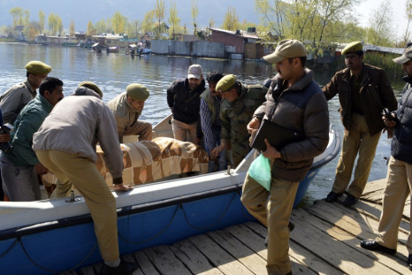 Indian police remove the body of a British woman from a motorboat on the banks of the Dal Lake in Srinagar