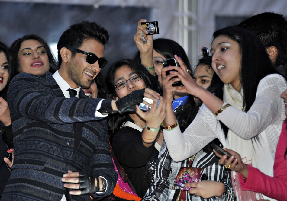 Singer Abbas Hasan of Canada greets fans as he arrives for the inaugural Times of India Film Awards in Vancouver, British Columbia April 6, 2013