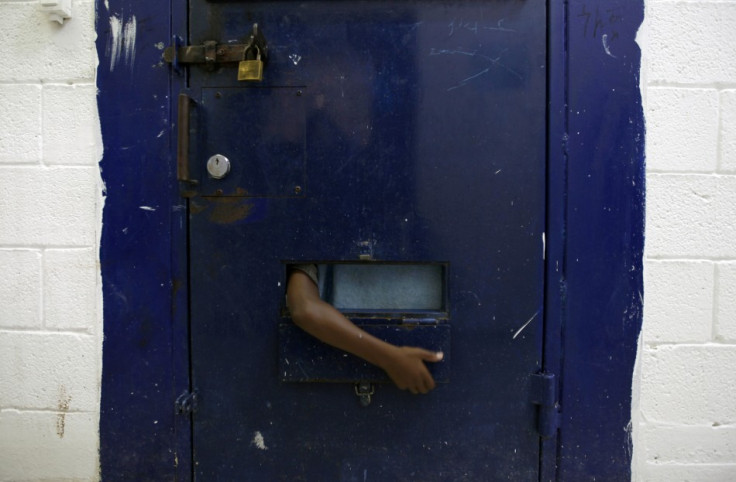 A young refugee from Eritrea reaches his arm out of his cell at Givon Prison in Ramle near Tel Aviv