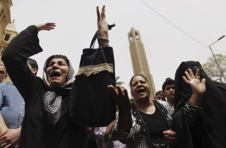 Coptic Christian (L and C) and Muslim (R) women shout slogans against Egyptian President Mohamed Mursi