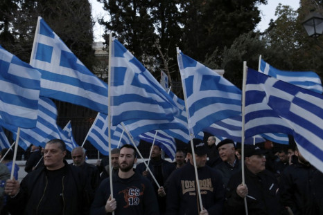 Supporters of the extreme-right Golden Dawn party hold Greek flags, during a rally over the crisis in Cyprus