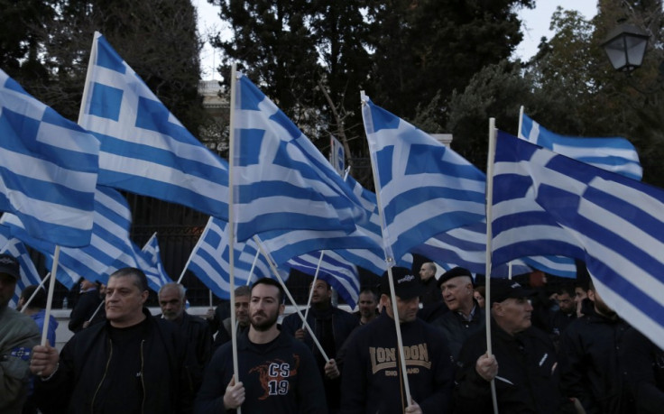 Supporters of the extreme-right Golden Dawn party hold Greek flags, during a rally over the crisis in Cyprus