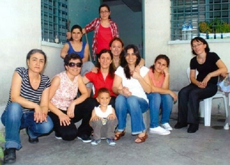 Meral Kurum (in red) sits behind her son, Renas, alongside  political prisoners in Bakirkoy Woman's Prison (Zeynep Kuray)