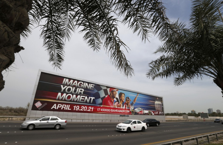 Vehicles travel past a large Bahrain Formula One advertising billboard on main highway leading to Bahrain Internaitonal Circuit