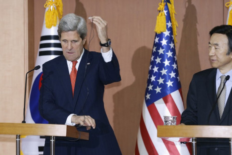 U.S. Secretary of State John Kerry (L) adjusts an earphone during a news conference with South Korean Foreign Minister Yun Byung-se