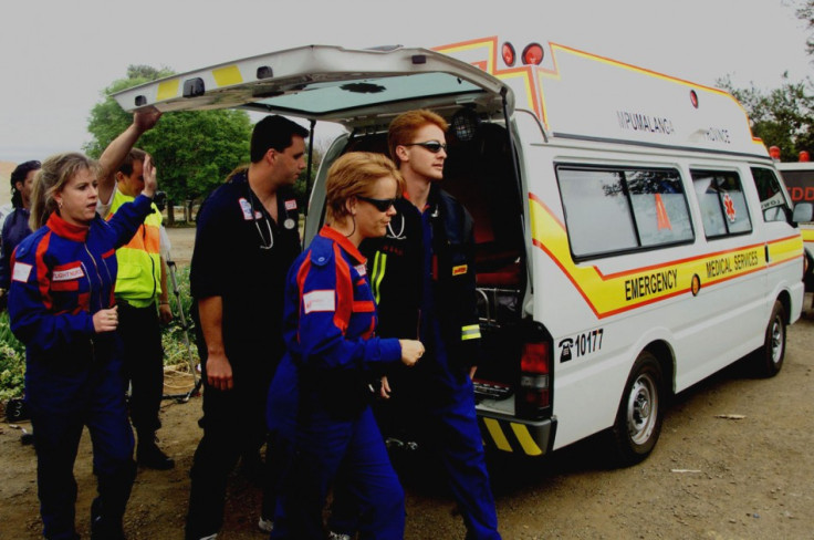 Medics help the victim of a South African road accident.