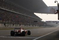 Fernando Alonso takes the chequered flag to win the Chinese Grand Prix