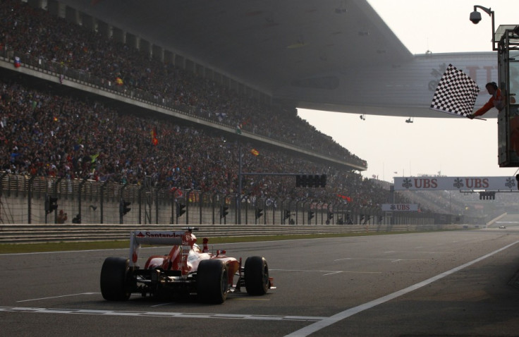 Fernando Alonso takes the chequered flag to win the Chinese Grand Prix