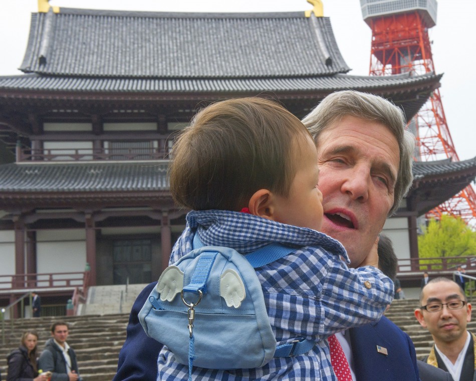 Kerry cuddles baby in Tokyo during mission to Asia