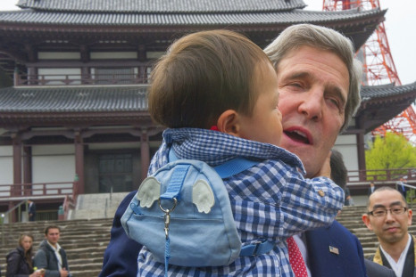 Kerry cuddles baby in Tokyo during mission to Asia