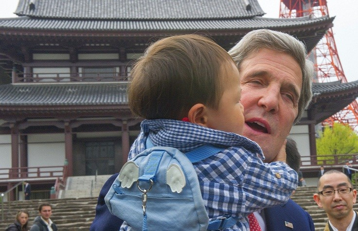 Kerry cuddles baby in Tokyo during mission to Asia