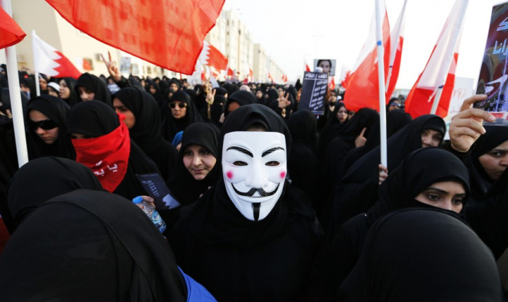 A female protester wearing a Guy Fawkes mask participates in an anti-government rally organised by Bahrain's main opposition group Al Wefaq