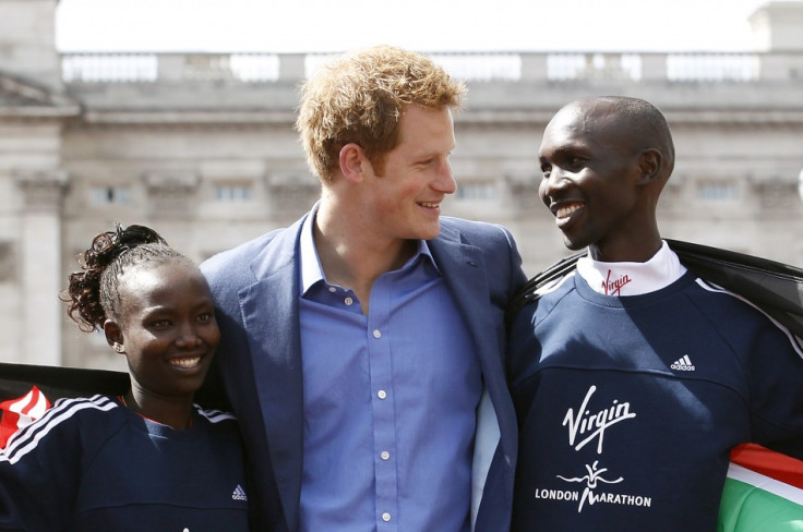 Prince Harry (centre) with runners Mary Keitany (L) and Wilson Kipsang