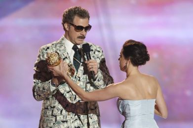 Actor Will Ferrell accepts the comedic genius award and actress Aubrey Plaza tries to prise it away at the 2013 MTV Movie Awards in Culver City, California April 14, 2013.