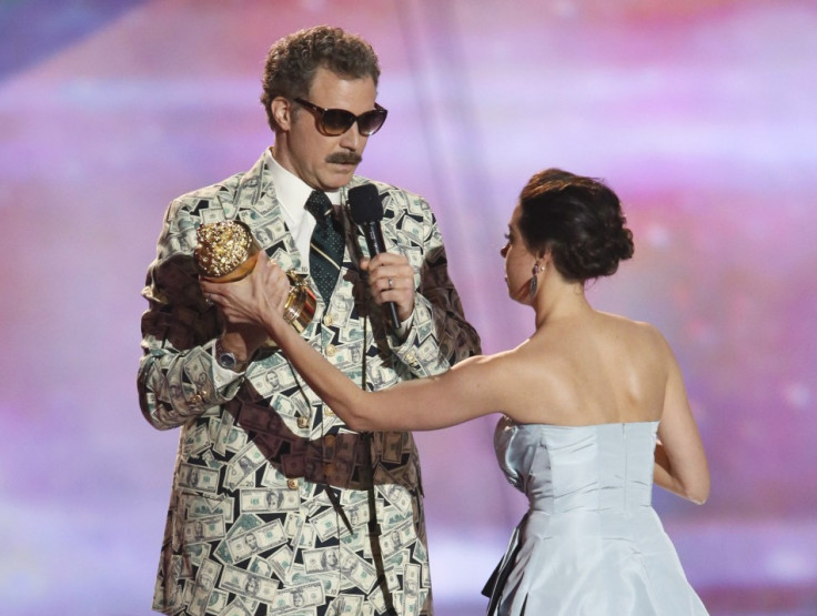 Actor Will Ferrell accepts the comedic genius award and actress Aubrey Plaza tries to prise it away at the 2013 MTV Movie Awards in Culver City, California April 14, 2013.