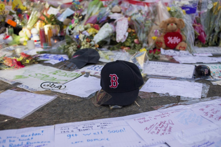 A Boston Red Sox hat is seen among a makeshift memorial for the victims of the Boston Marathon bombings on Boylston street