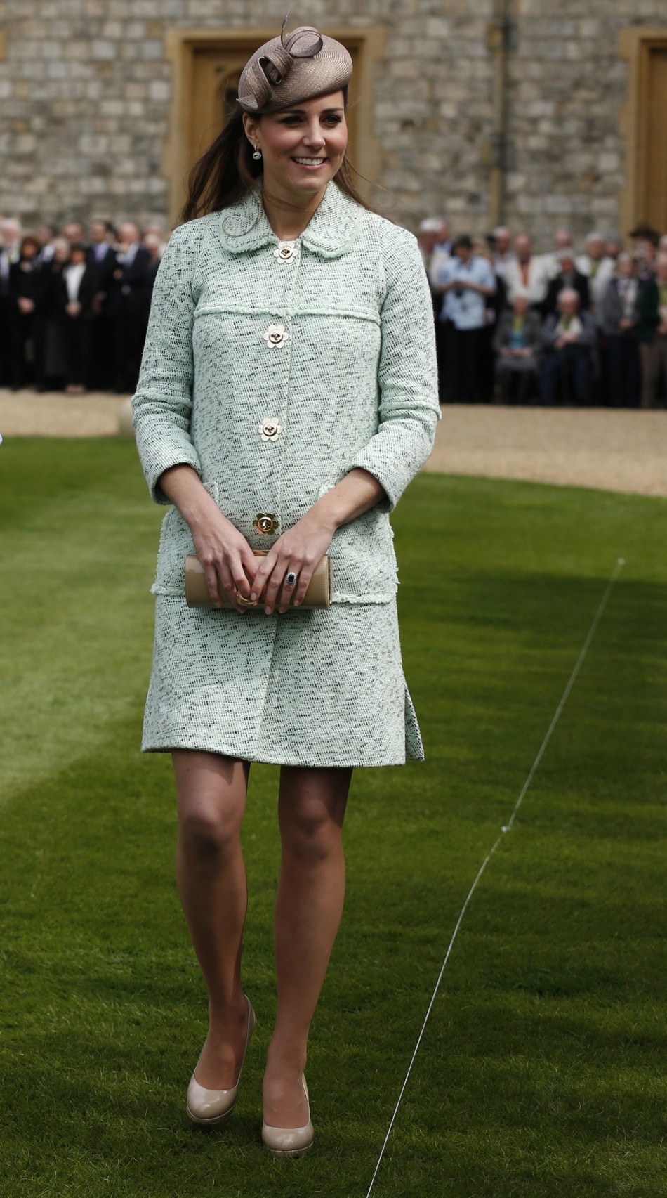 Britains Catherine, Duchess of Cambridge, showing visible signs of pregnancy, meets scouts during at the National Review of Queens Scouts at Windsor Castle in Berkshire, near London April 21, 2013.