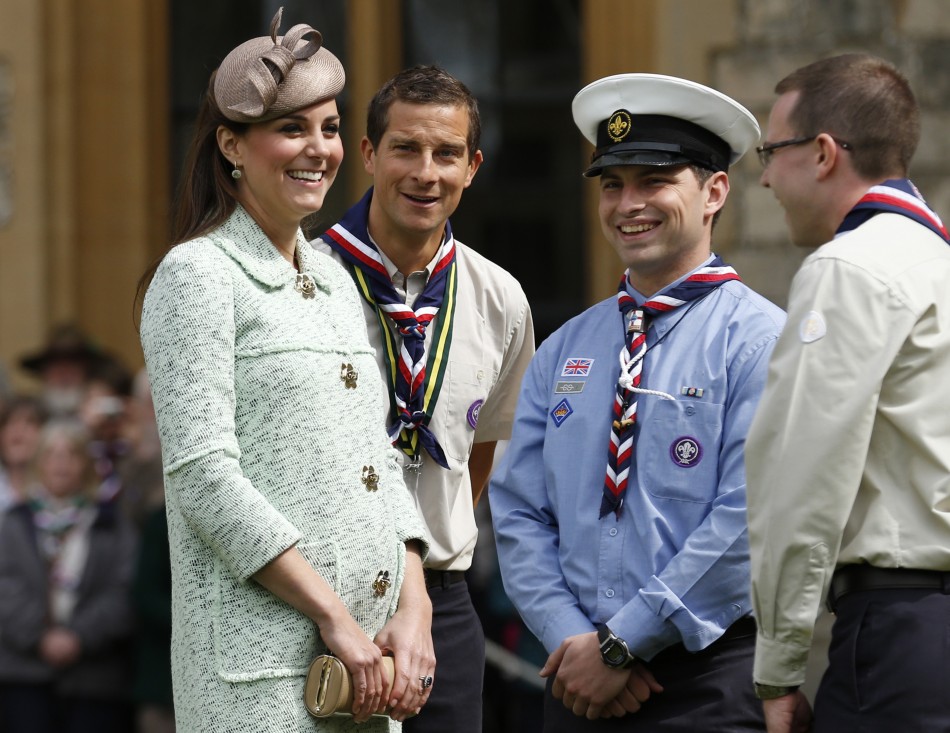 Britains Catherine, Duchess of Cambridge, showing visible signs of pregnancy, meets Chief Scout Bear Grylls 2nd L and Sea Scout Rob Butcher 2nd R while attending the National Review of Queens Scouts at Windsor Castle in Berkshire, near Lon