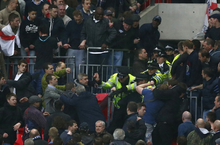 Millwall fans fight with police officers during their FA Cup semi-final game against Wigan Athletic at Wembley Stadium (Reuters)