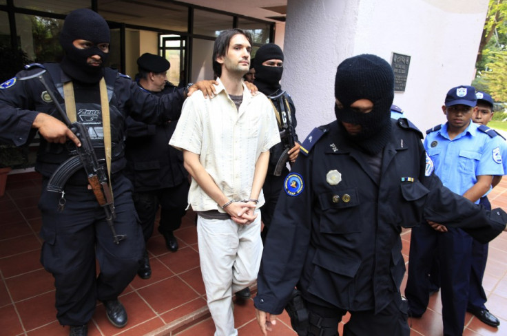 Eric Justin Toth is escorted after a presentation to the media at police headquarters building in Managua (Reuters)