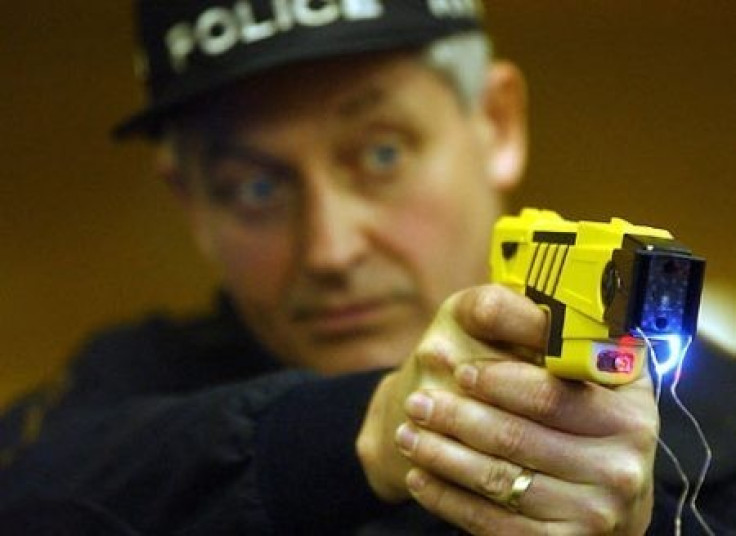 Police demonstrating the Taser gun. (Reuters)