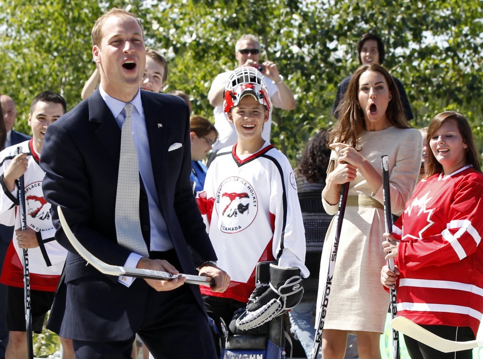 Prince William and his wife Catherine, the Duchess of Cambridge, react after the prince took a shot with a hockey stick and missed during a visit to the Somba Ke Civic Plaza in Yellowknife, Northwest Territories July 5, 2011.