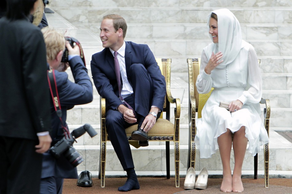 Prince William and Catherine, Duchess of Cambridge, take off their shoes before visiting the As-Syakirin Mosque at KLCC in Kuala Lumpur September 14, 2012.