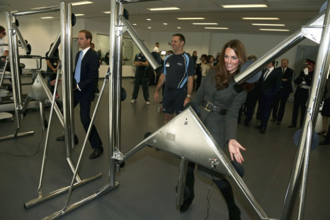Prince William and his wife Catherine, Duchess of Cambridge play a reaction game in the new gym during the official launch of The Football Association's National Football Centre at St George's Park in Burton upon Trent, central England October 9