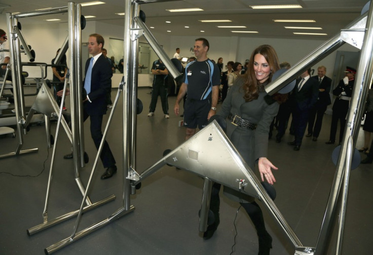 Prince William and his wife Catherine, Duchess of Cambridge play a reaction game in the new gym during the official launch of The Football Association's National Football Centre at St George's Park in Burton upon Trent, central England October 9