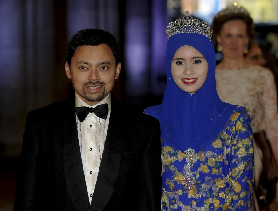 Bruneis Crown Prince Haji Al-Muhtadee Billah L and his wife Pengiran Anak Sarah arrive at a gala dinner organised on the eve of the abdication of Queen Beatrix of the Netherlands and the inauguration of her successor King Willem-Alexander at the R