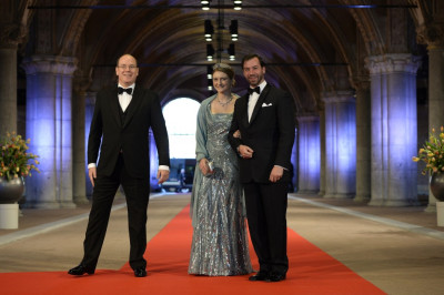 Prince Albert II L of Monaco arrives with Luxembourgs Hereditary Grand Duke Guillaume R and his wife Princess Stephanie at a gala dinner organised on the eve of the abdication of Queen Beatrix of the Netherlands and the inauguration of her succe