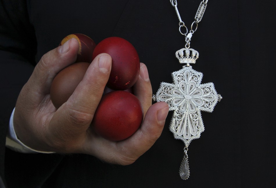 An Orthodox Christian priest holds Easter eggs during an Orthodox Easter mass at Saint Sava church in Mitrovica, May 5, 2013. Ethnic Serbs from the Serb-dominated northern part of the ethnically divided town of Mitrovica cross the bridge to attend a mass